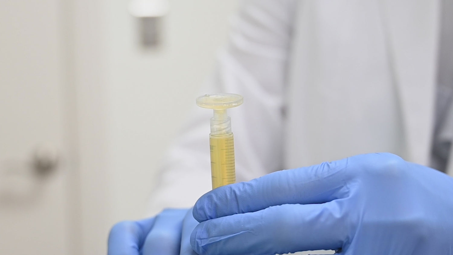 Novel medical device, CuraCator™, dispenses PRP on to a patient's face immediately following a laser resurfacing treatment. Patient's eyes are covered with medical grade covers and has visible texture on her face from the laser treatment. 